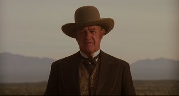 Movie still from “The Quick and the Dead” (1995), directed by Sam Raimi – An older man wearing a suit and a hat; Close Up shot, Low angle
