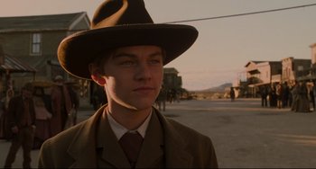 Movie still from “The Quick and the Dead” (1995), directed by Sam Raimi – A young man in a suit and a hat; Close Up shot, Low angle