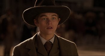 Movie still from “The Quick and the Dead” (1995), directed by Sam Raimi – A young man in a suit and a hat; Close Up shot, Low angle