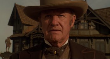 Movie still from “The Quick and the Dead” (1995), directed by Sam Raimi – An older man wearing a cowboy hat and a suit; Close Up shot, Low angle