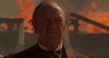 Movie still from “The Quick and the Dead” (1995), directed by Sam Raimi – An older man in a suit and tie; Close Up shot, Low angle