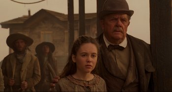 Movie still from “The Quick and the Dead” (1995), directed by Sam Raimi – A man and a woman standing next to each other; Medium shot, Over the shoulder angle