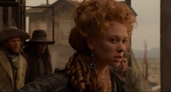 Movie still from “The Quick and the Dead” (1995), directed by Sam Raimi – A person with long red hair; Close Up shot, Low angle