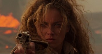 Movie still from “The Quick and the Dead” (1995), directed by Sam Raimi – A person holding a gun; Close Up shot, Low angle