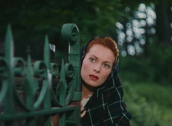 Movie still from “The Quiet Man” (1952), directed by John Ford – A woman with red hair and a blanket around her neck; Medium shot, High angle