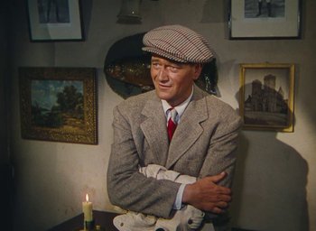 Movie still from “The Quiet Man” (1952), directed by John Ford – A wax statue of a man in a suit and hat; Medium shot, High angle
