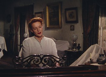 Movie still from “The Quiet Man” (1952), directed by John Ford – A woman sitting at a table in front of a mirror; Medium shot, Low angle