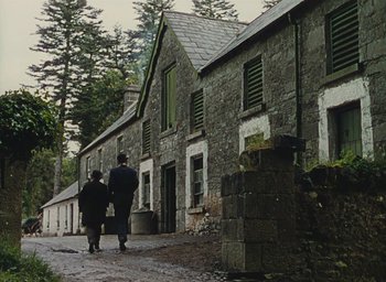 Movie still from “The Quiet Man” (1952), directed by John Ford – A man and a woman walking down a street; Extreme Wide shot, Low angle