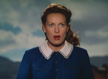 Movie still from “The Quiet Man” (1952), directed by John Ford – A woman in a blue dress with a white collar; Close Up shot, Low angle