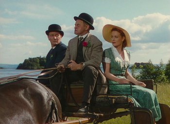 Movie still from “The Quiet Man” (1952), directed by John Ford – A group of people sitting on top of a carriage; Medium shot, Low angle