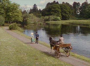 Movie still from “The Quiet Man” (1952), directed by John Ford – A horse drawn carriage on the side of a river; Extreme Wide shot, High angle