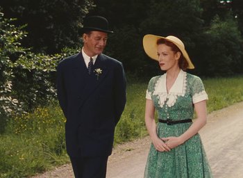Movie still from “The Quiet Man” (1952), directed by John Ford – An older man and a young woman standing next to each other; Medium shot, Low angle