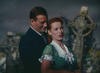 Movie still from “The Quiet Man” (1952), directed by John Ford – A man and a woman standing next to each other; Medium shot, Low angle