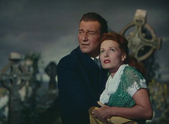 Movie still from “The Quiet Man” (1952), directed by John Ford – A man and a woman standing next to each other; Medium shot, Low angle
