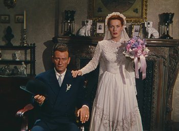Movie still from “The Quiet Man” (1952), directed by John Ford – A man and a woman dressed in wedding attire; Medium shot, High angle