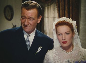 Movie still from “The Quiet Man” (1952), directed by John Ford – An older man and a younger woman standing next to each other; Close Up shot, High angle