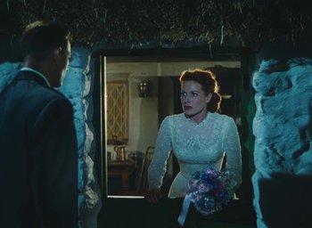 Movie still from “The Quiet Man” (1952), directed by John Ford – A man and a woman looking in a mirror; Medium shot, Over the shoulder angle
