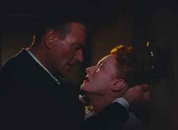 Movie still from “The Quiet Man” (1952), directed by John Ford – A man and a woman in formal wear looking into each others eyes; Close Up shot, Low angle