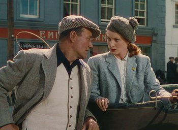 Movie still from “The Quiet Man” (1952), directed by John Ford – A man and a woman wearing matching hats; Medium shot, Low angle