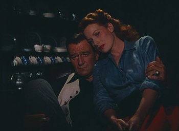 Movie still from “The Quiet Man” (1952), directed by John Ford – An older man sitting next to an older woman; Medium shot, High angle