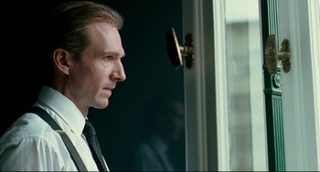 Movie still from “The Reader” (2008), directed by Stephen Daldry – A person wearing a suit and tie; Close Up shot, Over the shoulder angle