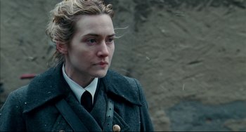 Movie still from “The Reader” (2008), directed by Stephen Daldry – A person wearing a coat and tie; Close Up shot, Over the shoulder angle