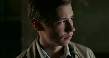 Movie still from “The Reader” (2008), directed by Stephen Daldry – A young man with short brown hair looking to his left; Close Up shot, Low angle