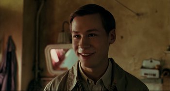 Movie still from “The Reader” (2008), directed by Stephen Daldry – A young man smiling for the camera in front of a mirror; Close Up shot, High angle