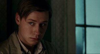 Movie still from “The Reader” (2008), directed by Stephen Daldry – A young man is looking into the camera; Close Up shot, Over the shoulder angle