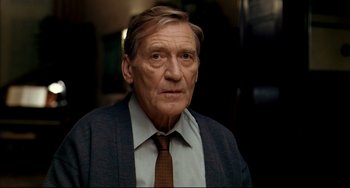 Movie still from “The Reader” (2008), directed by Stephen Daldry – An older man wearing a suit and a tie; Close Up shot, Low angle