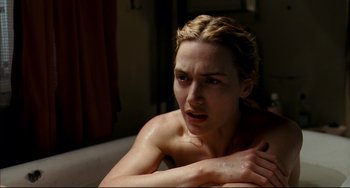 Movie still from “The Reader” (2008), directed by Stephen Daldry – A woman sitting on top of a couch in a room; Close Up shot, High angle