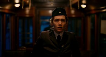 Movie still from “The Reader” (2008), directed by Stephen Daldry – A man in a uniform is posing for a picture; Close Up shot, Low angle