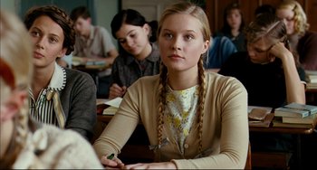 Movie still from “The Reader” (2008), directed by Stephen Daldry – A girl with plaited pigtails sitting in a classroom; Close Up shot, Over the shoulder angle