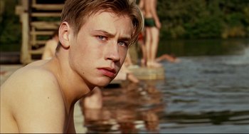 Movie still from “The Reader” (2008), directed by Stephen Daldry – A young man standing in a body of water; Close Up shot, Over the shoulder angle