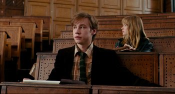 Movie still from “The Reader” (2008), directed by Stephen Daldry – A man and a woman sitting in a courtroom; Medium shot, Low angle