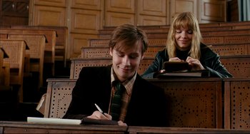 Movie still from “The Reader” (2008), directed by Stephen Daldry – A man and a woman sitting in a lecture hall; Medium shot, Low angle