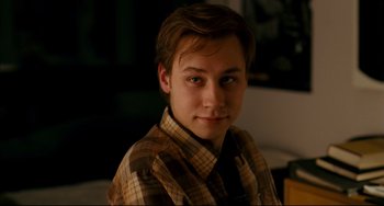 Movie still from “The Reader” (2008), directed by Stephen Daldry – A young man wearing a plaid shirt and a tie; Close Up shot, Over the shoulder angle
