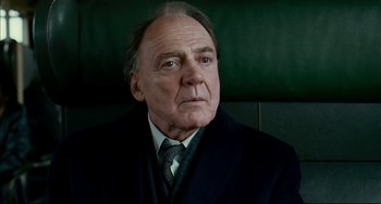 Movie still from “The Reader” (2008), directed by Stephen Daldry – An older man wearing a suit and tie; Close Up shot, Low angle