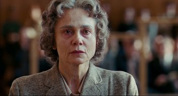 Movie still from “The Reader” (2008), directed by Stephen Daldry – An older woman with grey curly hair wearing a suit; Close Up shot, Low angle