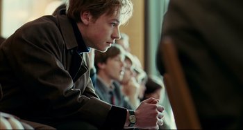Movie still from “The Reader” (2008), directed by Stephen Daldry – A man sitting in front of a group of other people; Close Up shot, Over the shoulder angle