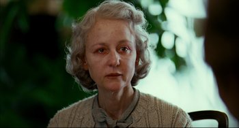Movie still from “The Reader” (2008), directed by Stephen Daldry – An older woman wearing a sweater and a bow tie; Close Up shot, Low angle