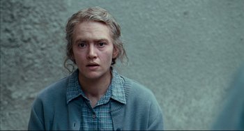 Movie still from “The Reader” (2008), directed by Stephen Daldry – A person with long blonde hair wearing a plaid shirt; Close Up shot, Over the shoulder angle