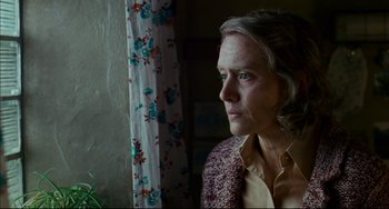 Movie still from “The Reader” (2008), directed by Stephen Daldry – An older woman looking out of a window; Close Up shot, Low angle