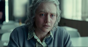 Movie still from “The Reader” (2008), directed by Stephen Daldry – An older woman is looking at the camera; Close Up shot, Over the shoulder angle