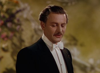 Movie still from “The Red Shoes” (1948), directed by Michael Powell – A man wearing a tuxedo and a bow tie; Close Up shot, Low angle