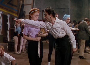 Movie still from “The Red Shoes” (1948), directed by Michael Powell – A man and a woman are dancing in a dance studio; Medium shot, Over the shoulder angle