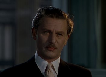 Movie still from “The Red Shoes” (1948), directed by Michael Powell – A person wearing a suit and tie; Close Up shot, Low angle