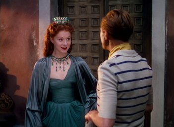 Movie still from “The Red Shoes” (1948), directed by Michael Powell – A woman wearing a crown and a dress; Medium shot, Over the shoulder angle