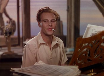 Movie still from “The Red Shoes” (1948), directed by Michael Powell – A man sitting in front of an open piano; Close Up shot, Low angle