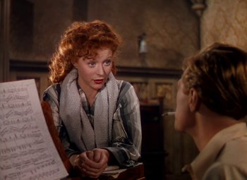 Movie still from “The Red Shoes” (1948), directed by Michael Powell – A red headed woman is talking to another woman; Medium shot, Over the shoulder angle